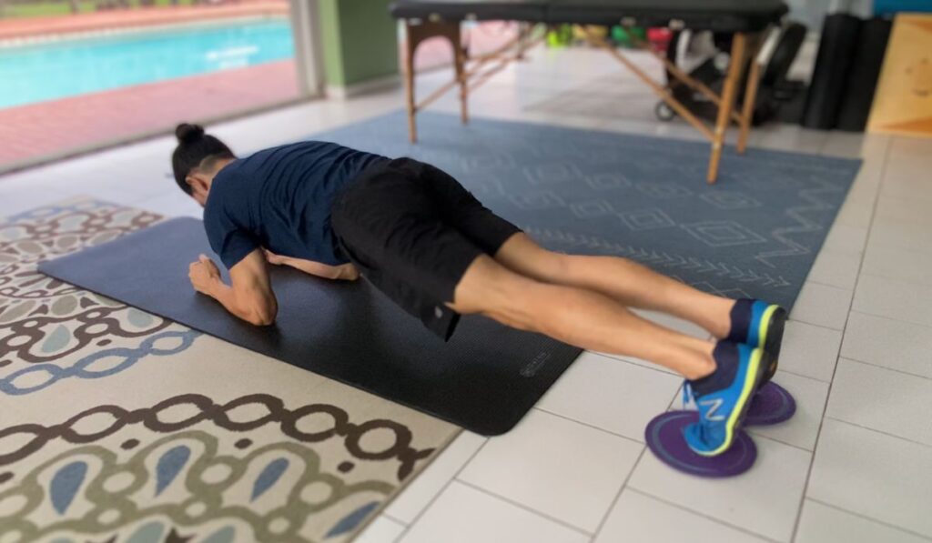 The body saw with sliders is an anti-extension exercise used to target the core muscles.